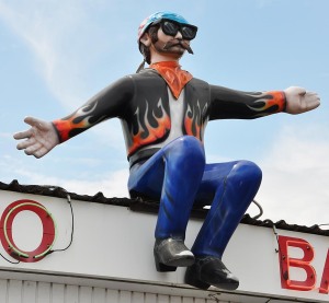 The above cowboy was re-purposed in Illinois to look like a biker and sat atop a discount liquor store.